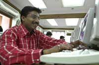 An Indian stockbroker works at the Bombay Stock Exchange, where the index reached an all-time high on February 14, 2005